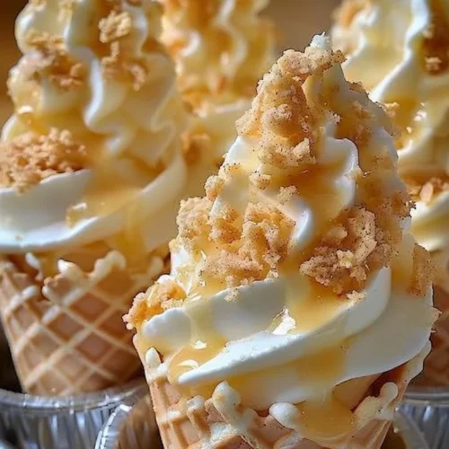 Banana Pudding Cheesecake Cones served in a waffle cone with whipped cream