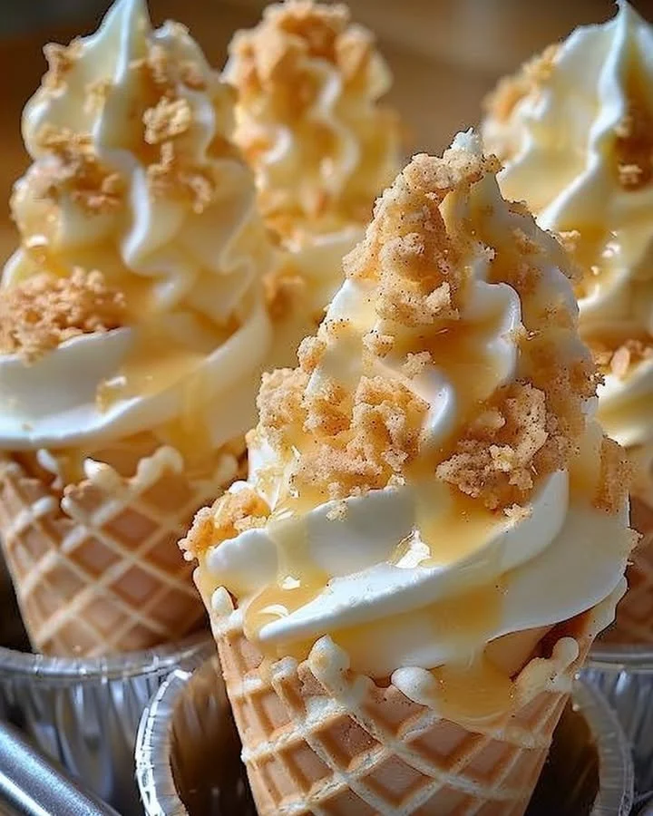 Banana Pudding Cheesecake Cones served in a waffle cone with whipped cream