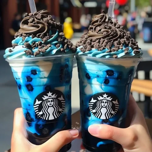 Blue Cookies & Cream Dip Frappuccinos garnished with whipped cream