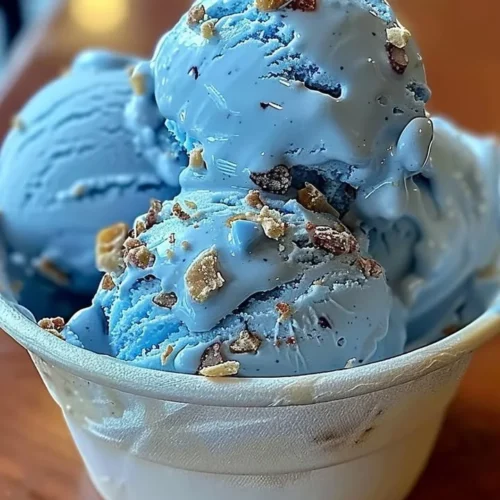A bowl of Blue Moon Ice Cream topped with sprinkles and cherries