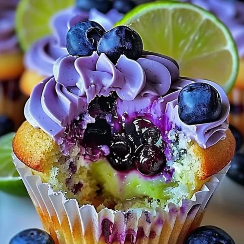 Blueberry lime cheesecake cupcakes topped with fresh blueberries and lime zest.