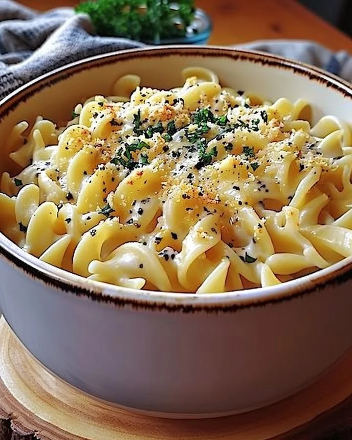 Plate of cafeteria noodles with colorful vegetables and sauce