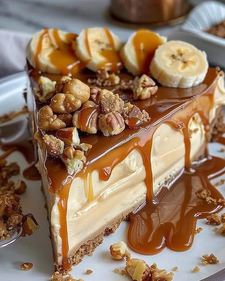 Delicious Caramel Banana Crunch Cheesecake topped with caramel and crunchy bananas