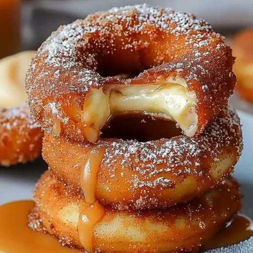 Caramel cheesecake-stuffed churro rings with a drizzle of caramel sauce