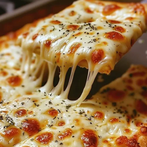 Plate of freshly baked cheesy breadsticks with golden melted cheese