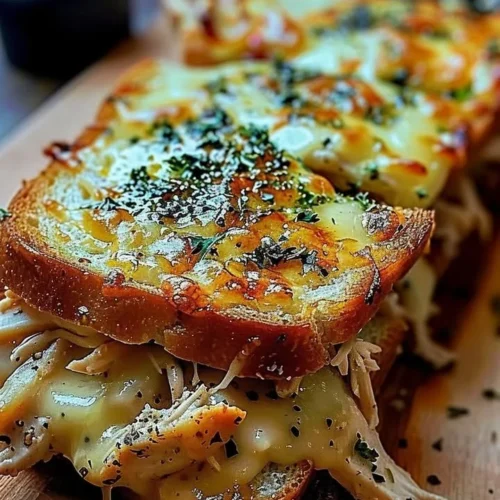 Delicious cheesy chicken sandwich on garlic bread with melted cheese