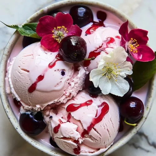 Scoop of Cherry Blossom Ice Cream in a cone with cherry blossoms in the background