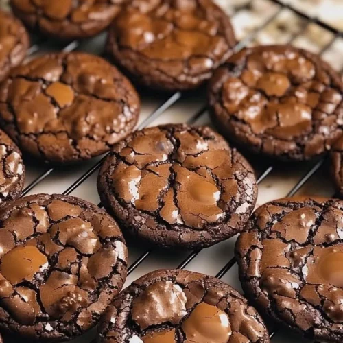 Batch of chewy fudgy chocolate cookies on a plate, ready to enjoy.