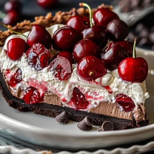 Delicious Chocolate Cherry Cream Pie with whipped cream topping and cherries