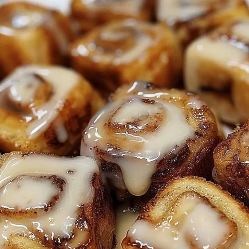 Cinnamon roll French toast bites topped with icing and cinnamon.