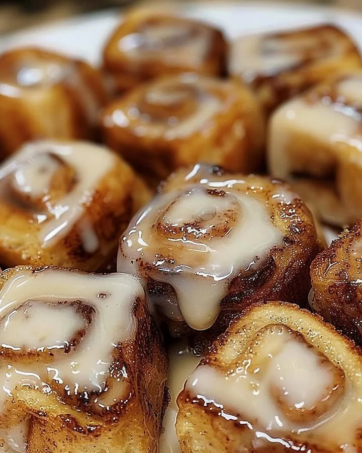 Cinnamon roll French toast bites topped with icing and cinnamon.