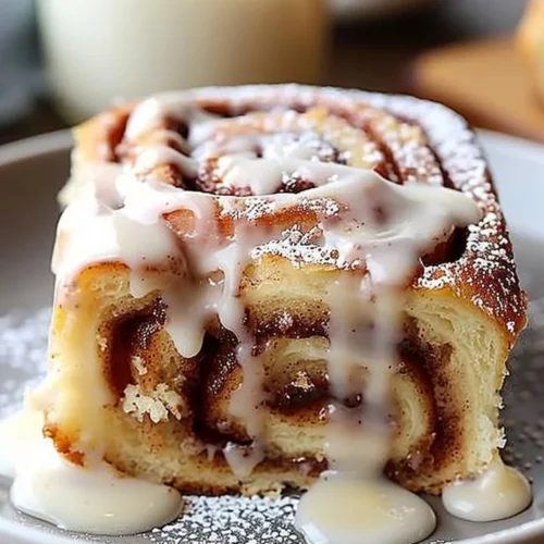 Delicious cinnamon roll poke cake with frosting and cinnamon topping