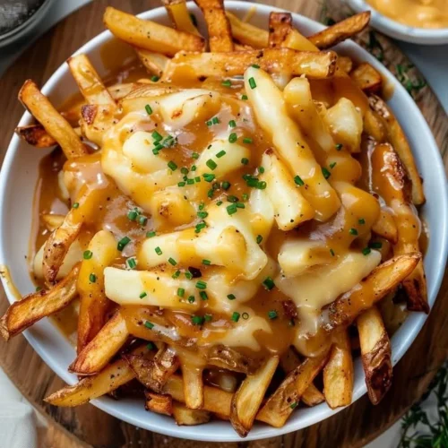 A delicious plate of Classic Canadian Poutine with fries, cheese curds, and gravy.
