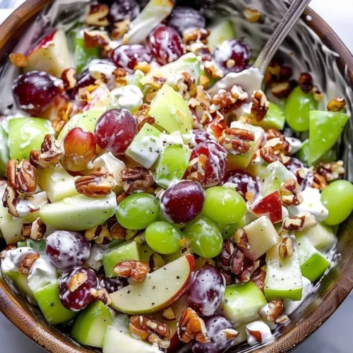 Classic Waldorf salad with apples, walnuts, and celery on a plate.