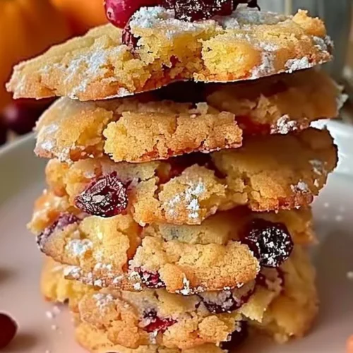 Cranberry orange shortbread cookies arranged on a festive plate