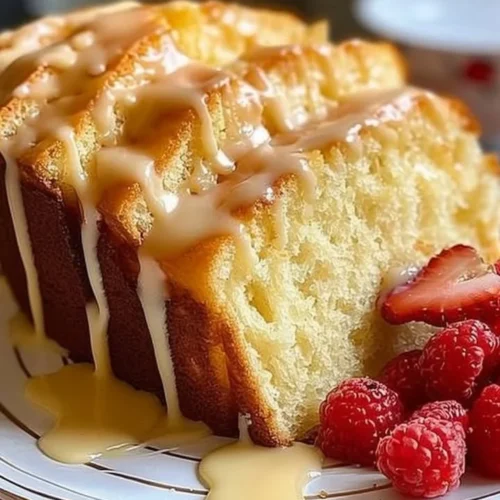 Delicious cream cheese pound cake served on a plate, showcasing its moist texture.