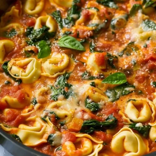 Creamy tomato basil tortellini skillet served in a rustic bowl