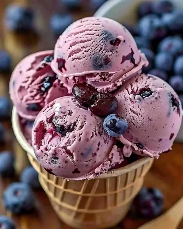Delicious Crimson Choco Rhapsody Ice Cream in a cone topped with chocolate syrup.
