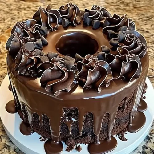 Decadent Death by Chocolate Cake topped with rich chocolate ganache.