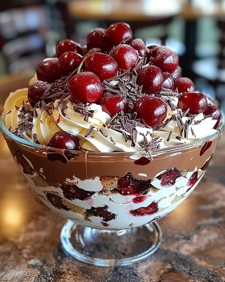 Decadent cherry chocolate trifle layered with cherries and chocolate cream.