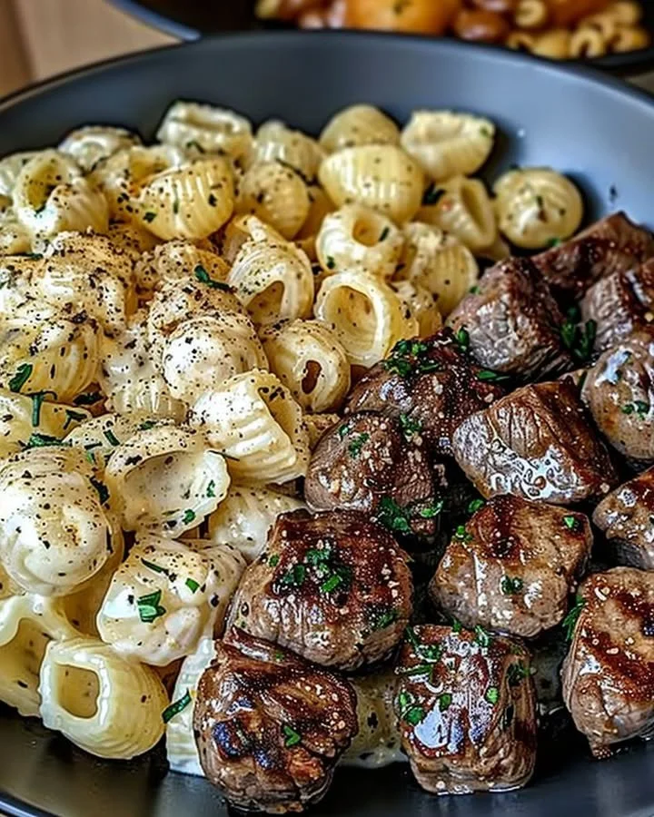 Delicious Garlic Butter Steak Bites served with creamy Parmesan pasta shells