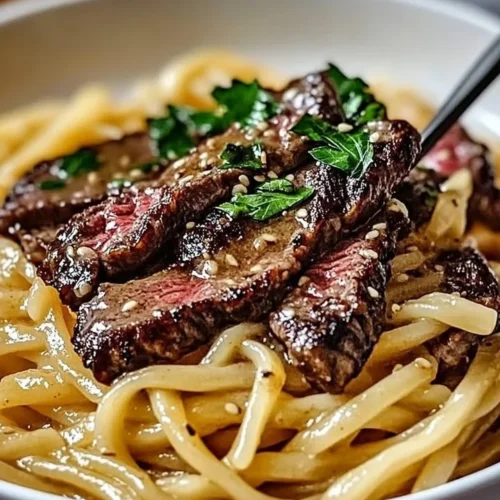 Garlic Butter Steak Lightning Noodles served in a bowl with fresh herbs