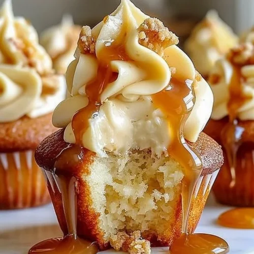 Gooey salted caramel cream cheese cupcakes with drizzled caramel on top