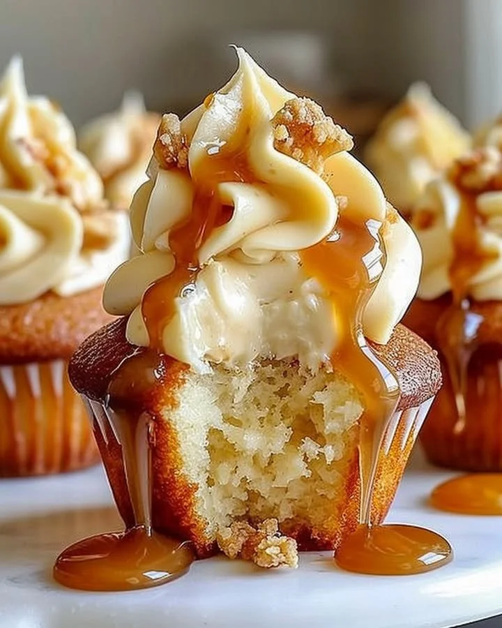Gooey salted caramel cream cheese cupcakes with drizzled caramel on top