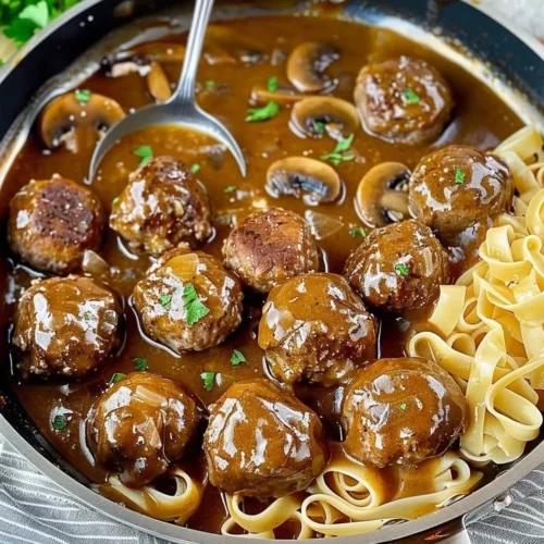 Gourmet meatballs served with rich mushroom gravy on a plate.