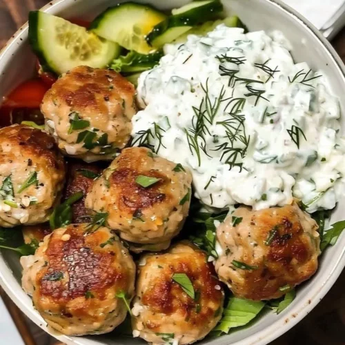 Plate of Greek chicken meatballs with homemade tzatziki sauce