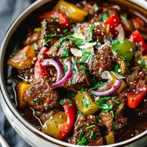 Delicious Guinness Braised Beef Stew served in a bowl with fresh herbs