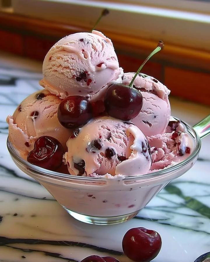 Creamy homemade cherry ice cream topped with fresh cherries