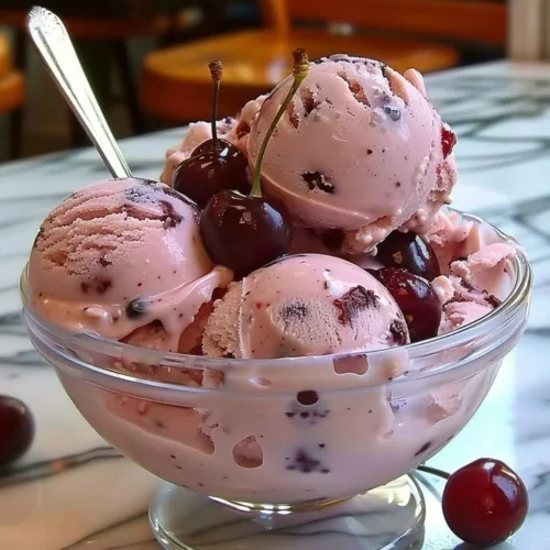 Delicious homemade cherry ice cream served in a bowl with fresh cherries