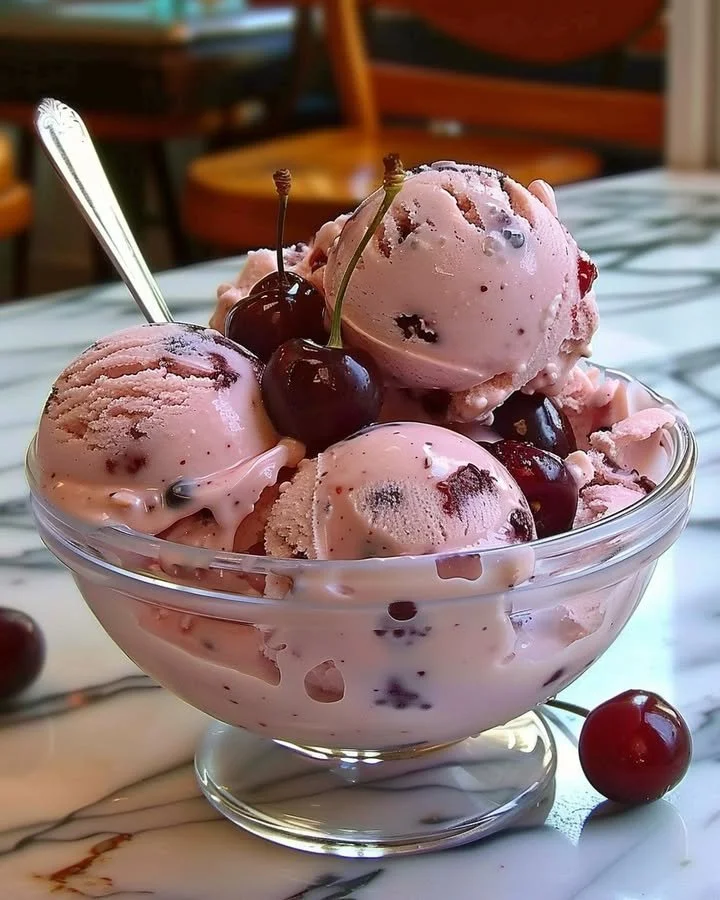 Delicious homemade cherry ice cream served in a bowl with fresh cherries