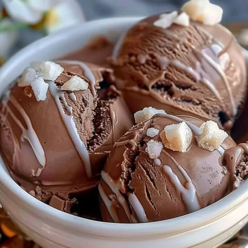 A bowl of rich homemade chocolate ice cream topped with chocolate shavings