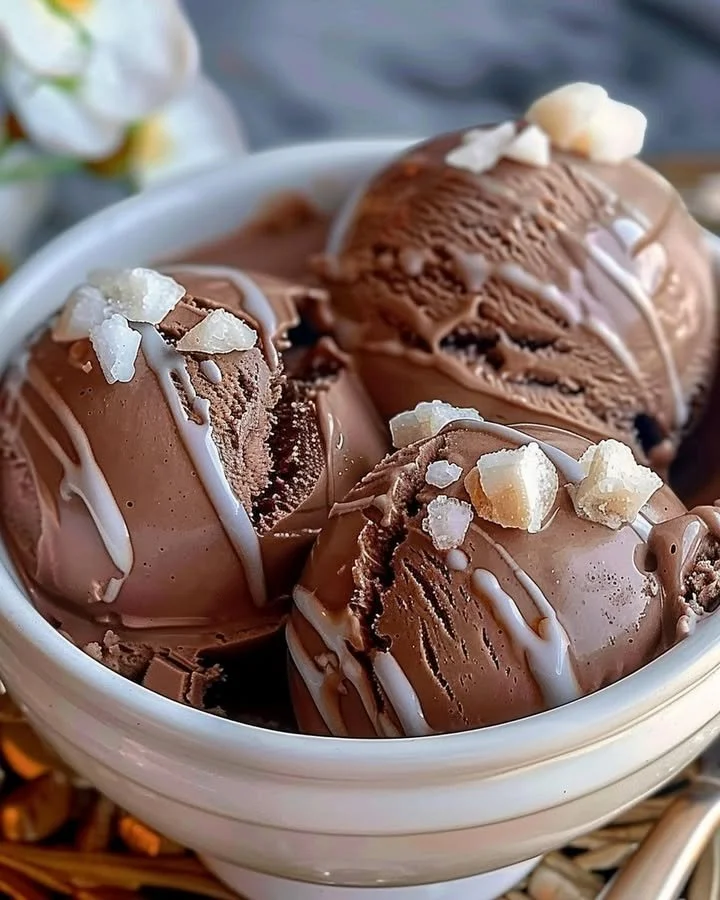 A bowl of rich homemade chocolate ice cream topped with chocolate shavings