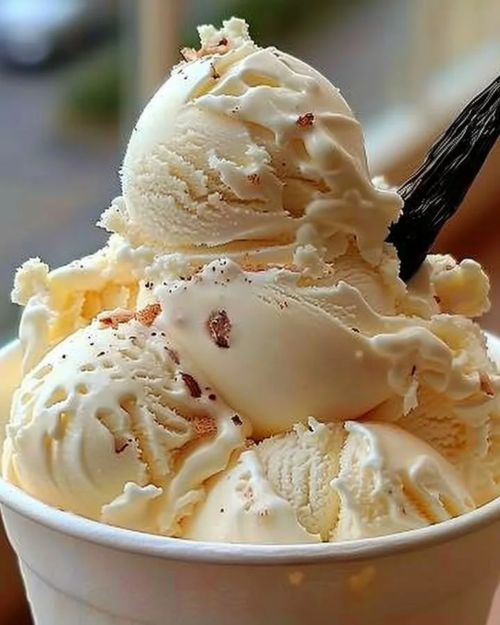 Bowl of homemade vanilla ice cream with fresh mint leaves on top