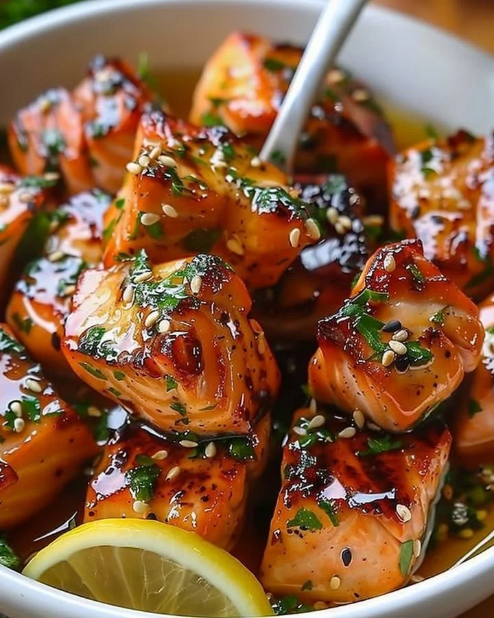 Delicious Honey Butter Garlic Salmon Bites drizzled with glaze on a plate