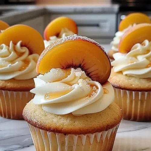 Delicious honey peach cream cheese cupcakes topped with peach frosting