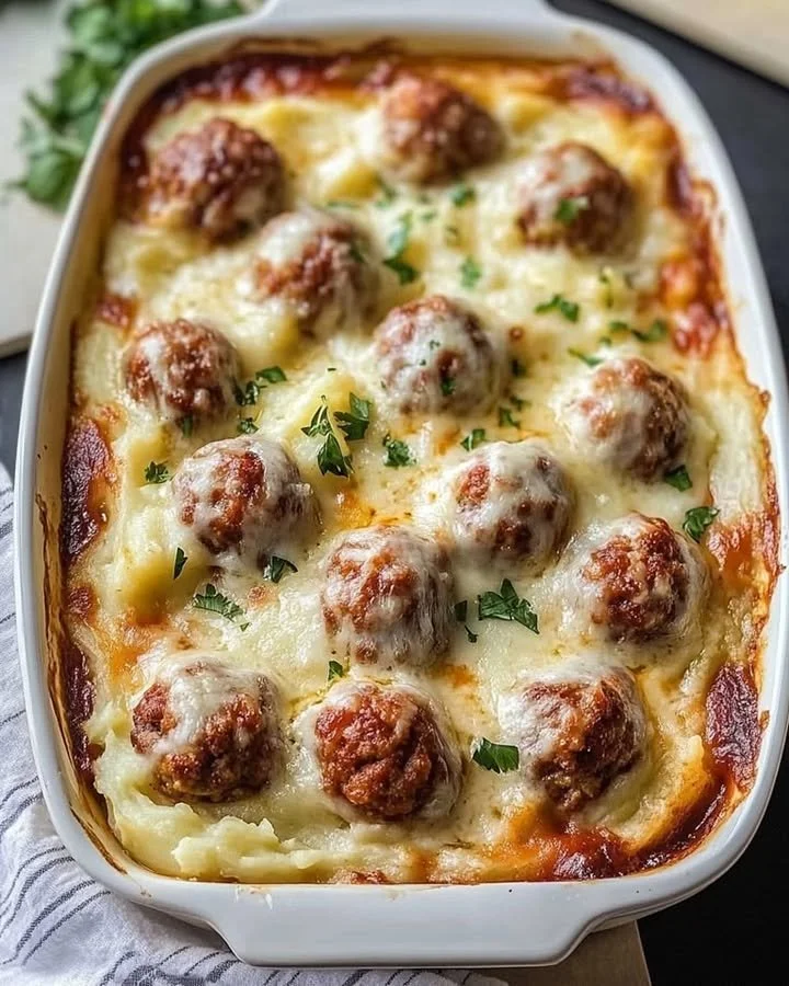 Loaded mashed potatoes casserole topped with meatballs and cheese