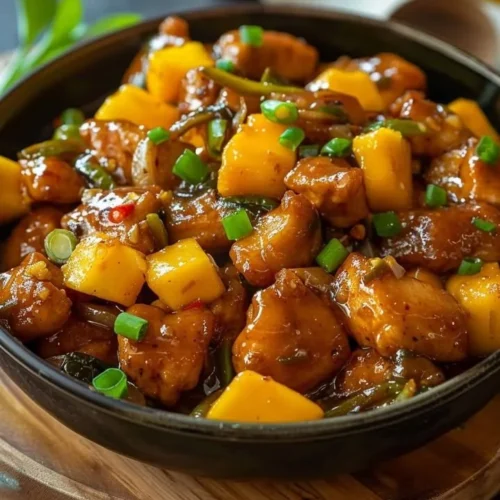 Delicious Mango Chili Chicken served with vibrant vegetables