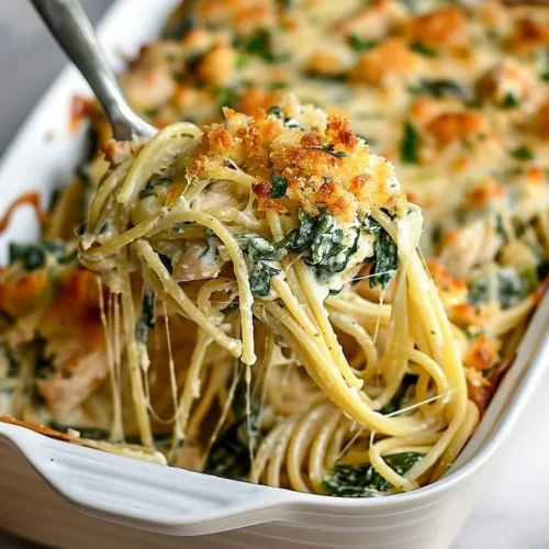 Baked Monterey Chicken Spaghetti with cheese and herbs in a casserole dish