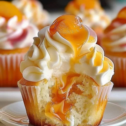 Delicious peach cupcakes with creamy frosting and fresh peach slices on top