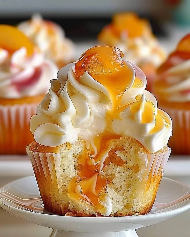 Delicious peach cupcakes with creamy frosting and fresh peach slices on top