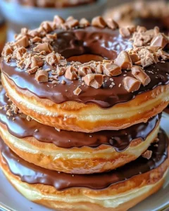Peanut Butter Reese’s Donut Sandwiches served on a plate with garnish.