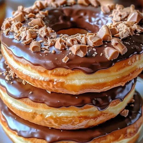 Peanut Butter Reese’s Donut Sandwiches served on a plate with garnish.