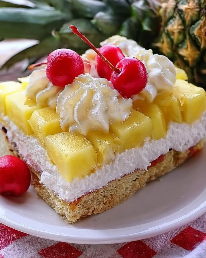 Delicious Pineapple Heaven Cake topped with fresh pineapple and whipped cream
