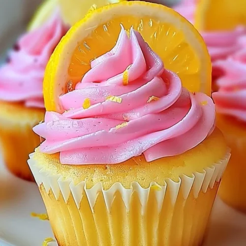 Pink lemonade cupcakes topped with pink frosting and lemon zest decoration