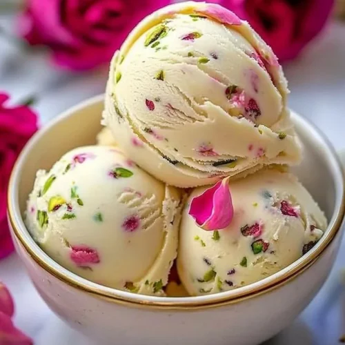 A delicious scoop of pistachio cheesecake ice cream in a waffle cone.