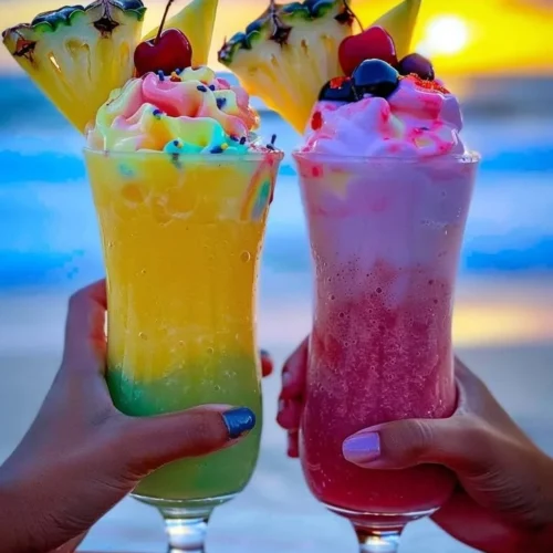 Colorful Rainbow Sherbet Piña Colada in a glass with a tropical garnish